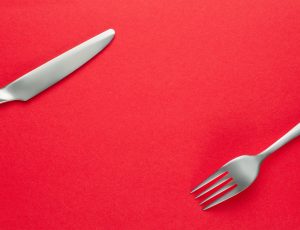 Fork and knife on red background